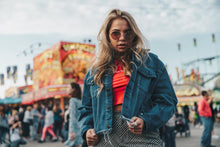 Load image into Gallery viewer, Woman wearing a denim jacket at an amusement park
